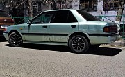 Mazda 323, 1.6 механика, 1991, седан Шымкент